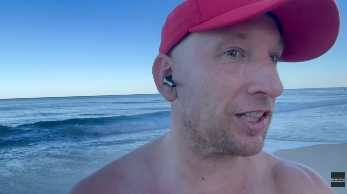 Andrew Hough testing earbuds at the beach